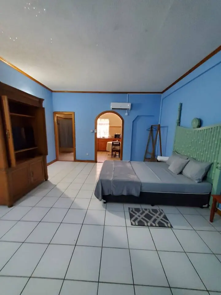 Spacious room with bed and wardrobe