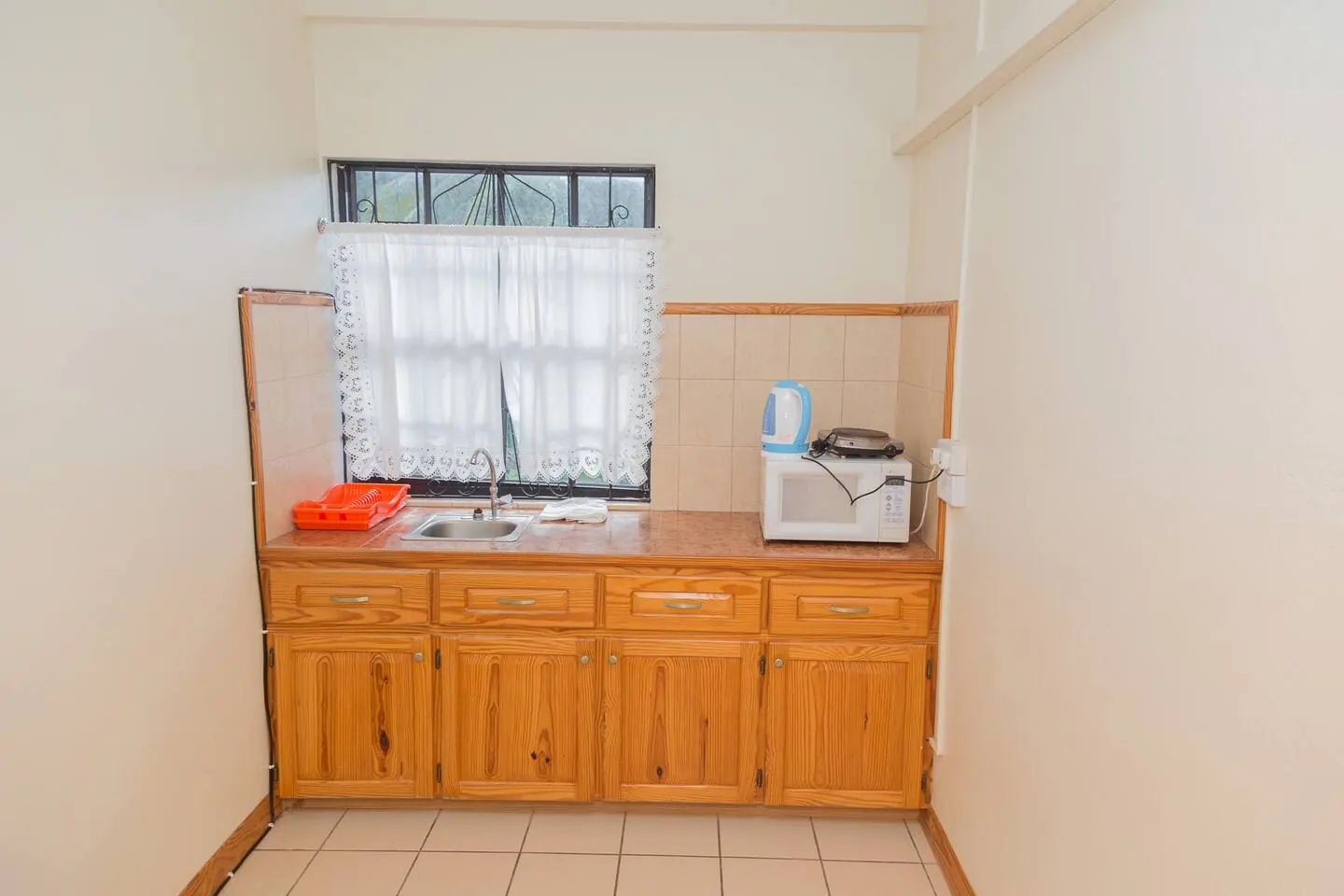 Kitchenette with cabinets and microwave