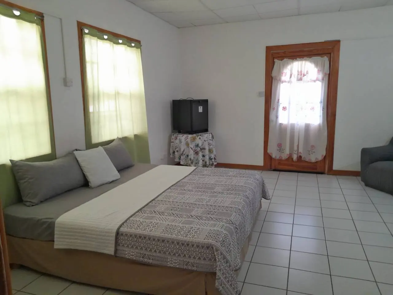 Bedroom with king bed and armchair
