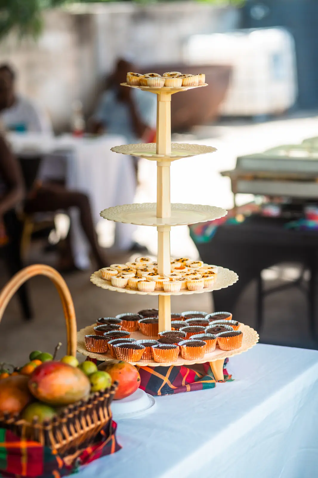 Tiered dessert stand and fruit basket on the buffet