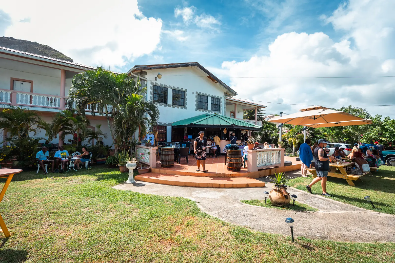 Guests on the lawn beside the guesthouse during a lunch event