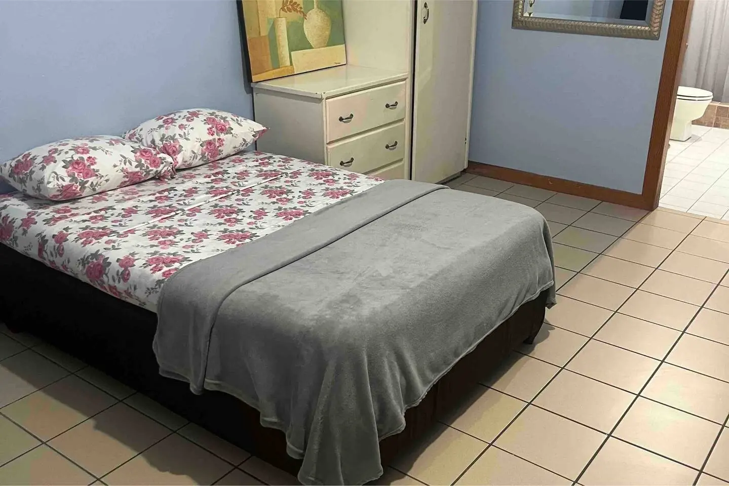 Bedroom with double bed and tiled floor