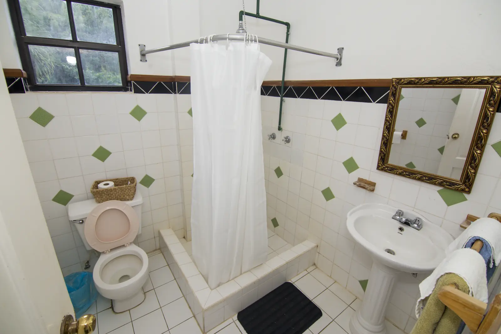 Bathroom with shower and green tile accents
