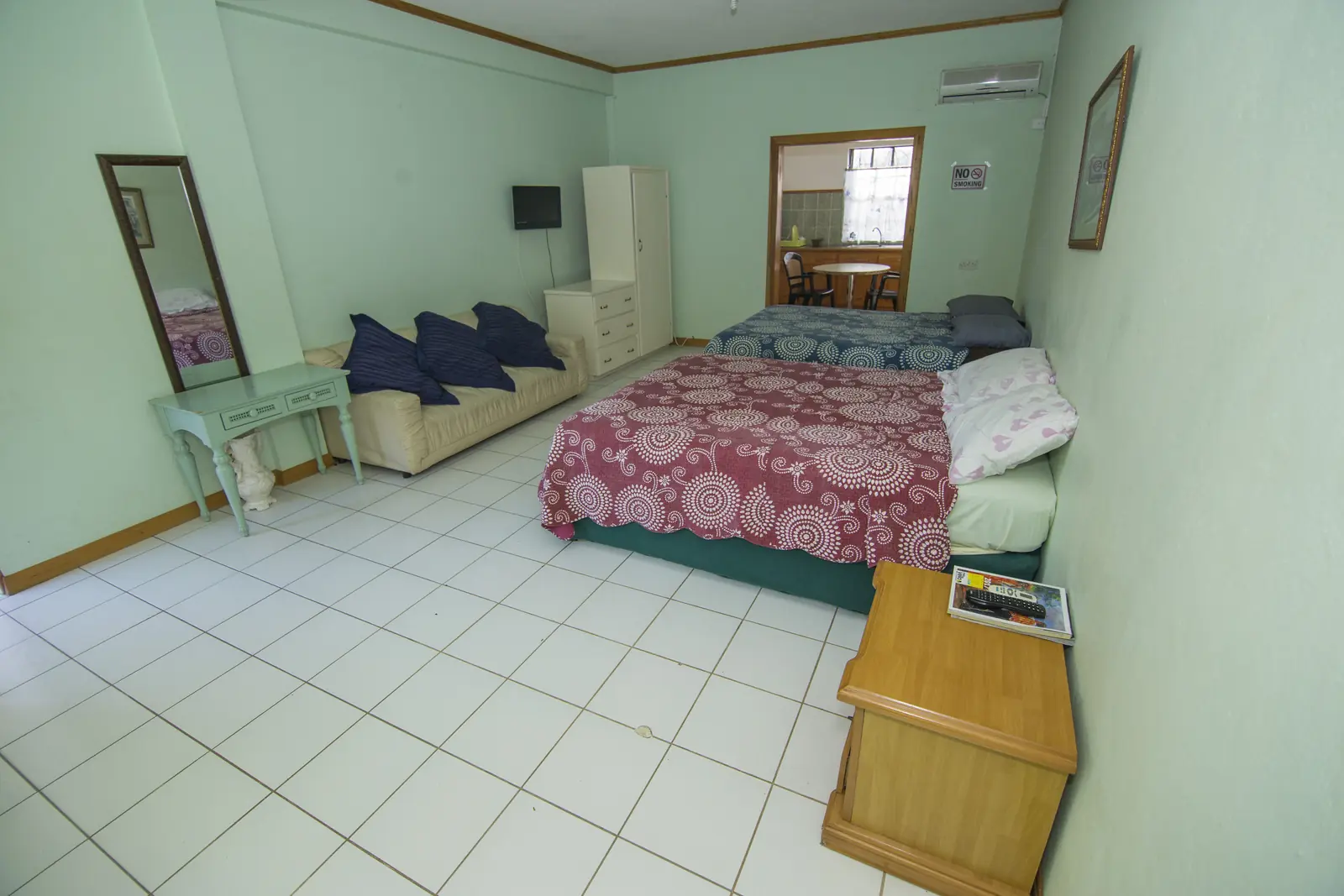 Guest room with two beds and mint-green walls