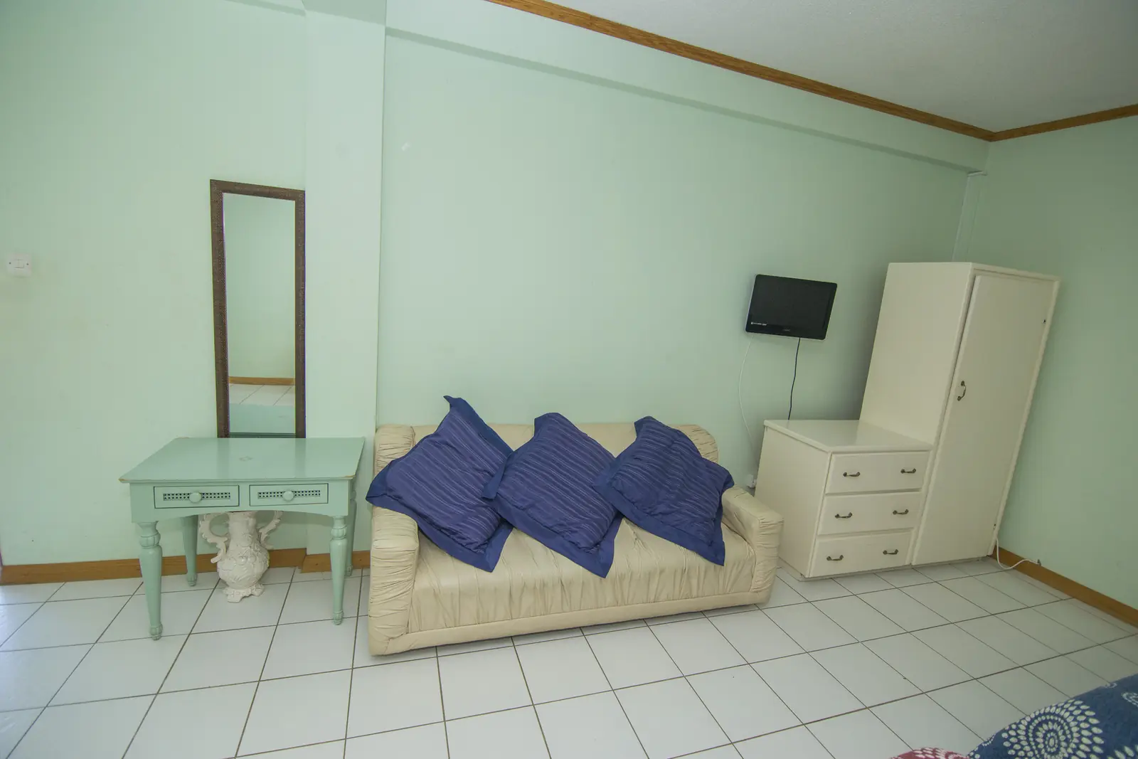 Sitting area with sofa, dresser and TV