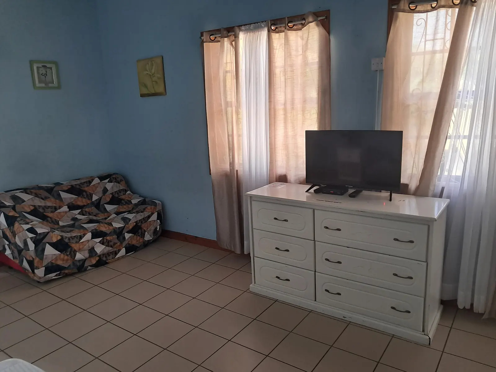 Sitting area with sofa, dresser and TV